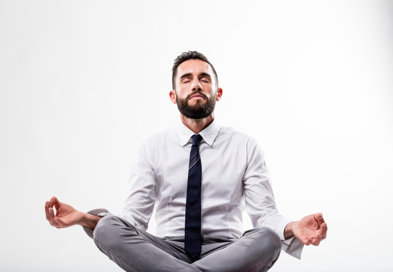 Man in suit meditating- article on initial challenges in business