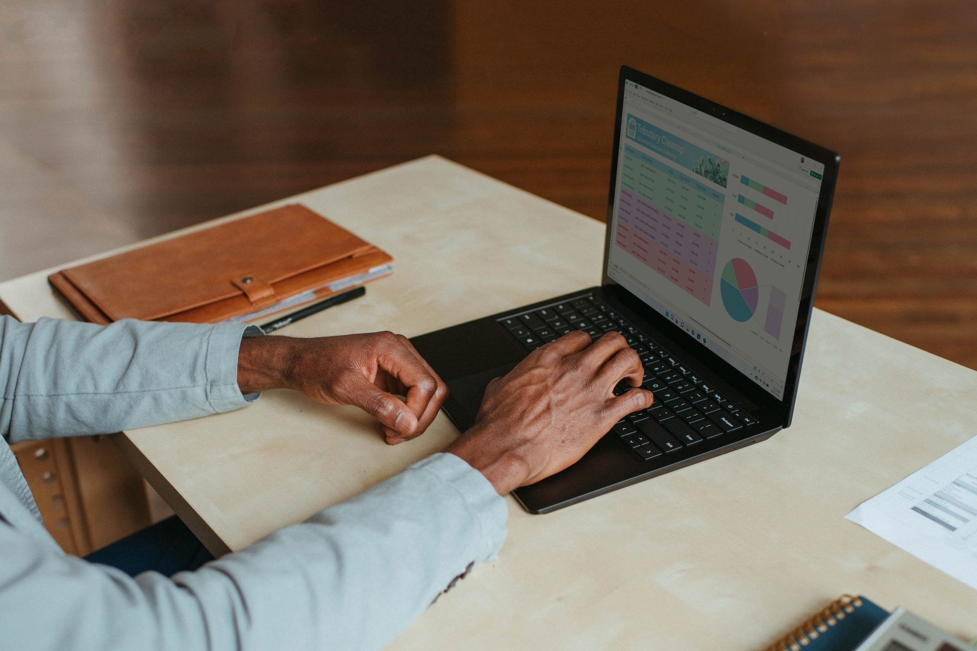 man's hands over laptop, working at desk